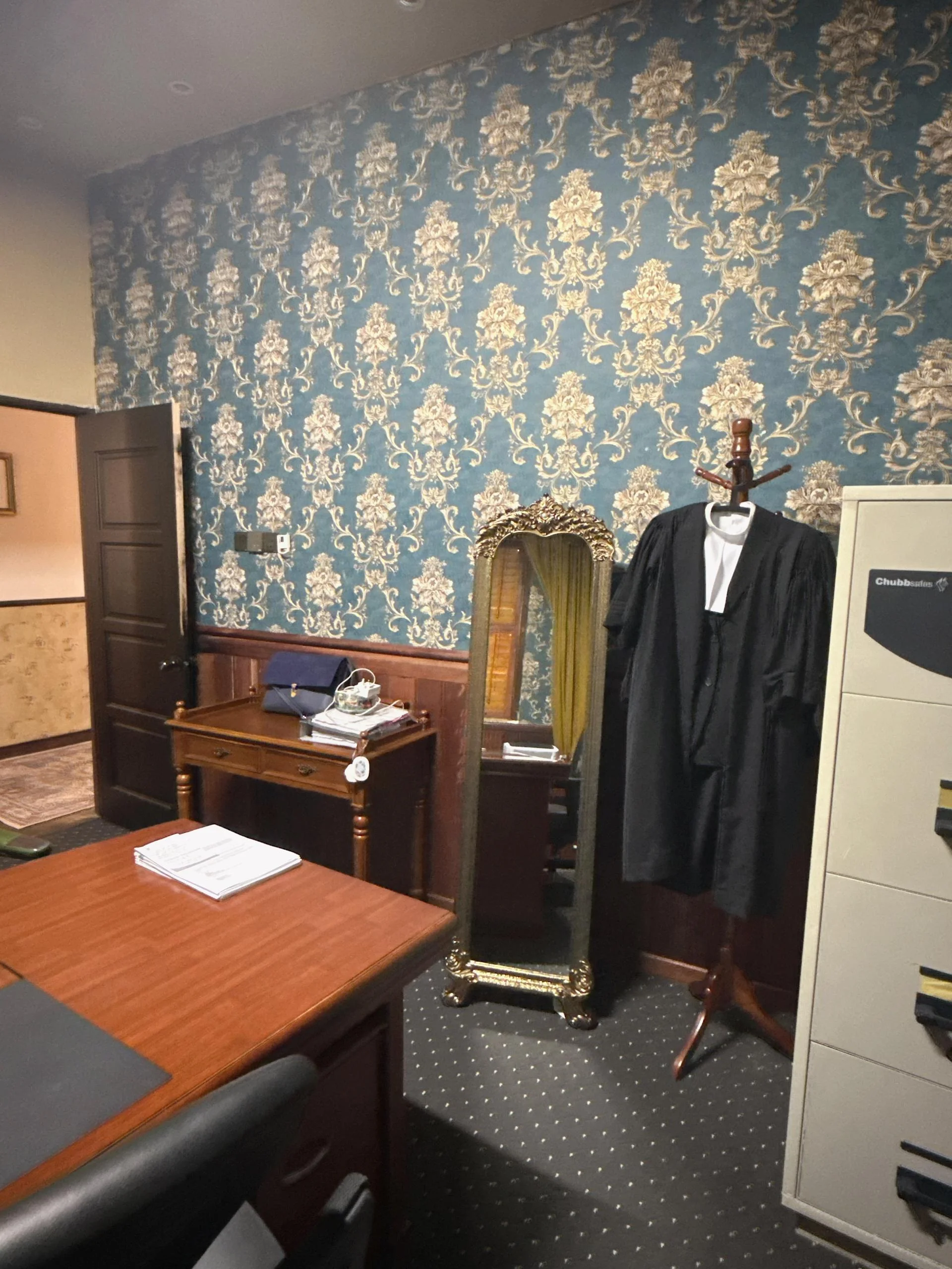 Interior of Amely Khoo office with uniforms hanging on display